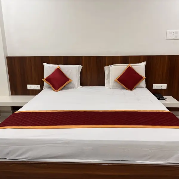 Executive Room bed with warm wood panelling