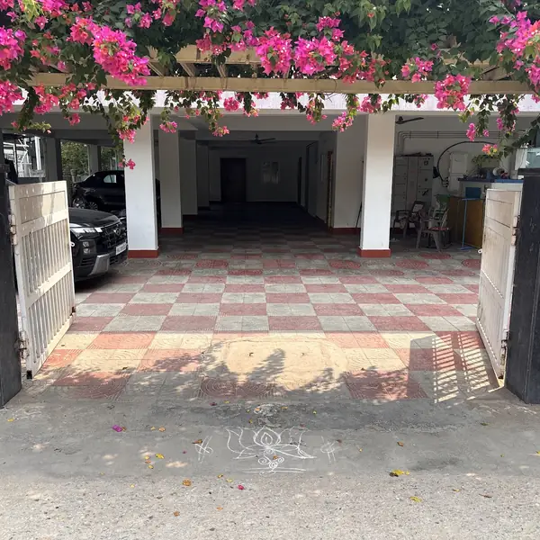 Entrance gate under a bougainvillea arch