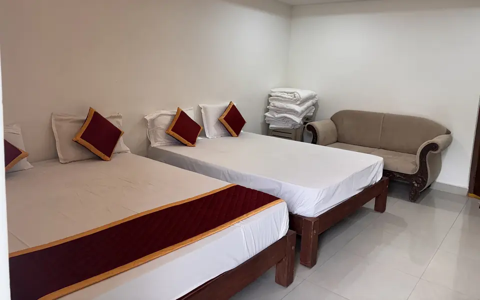 Family Suite with two beds and sofa seating at Arcade Stay Inn, Tirupati